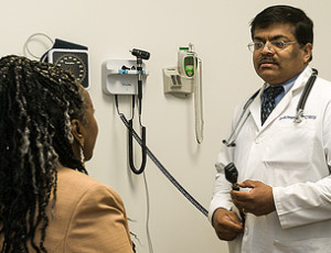 Dr. Kanjaarpane with patient in exam room