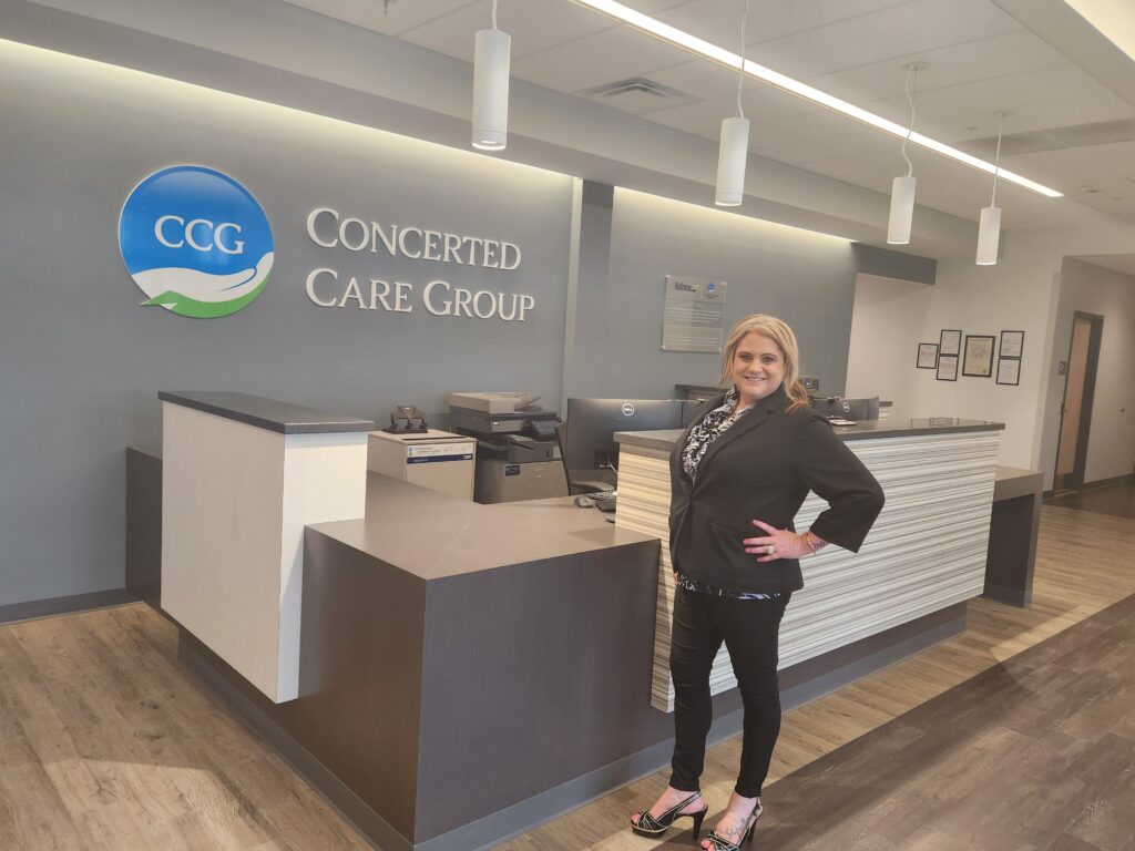 Person in a lobby standing in front of a desk